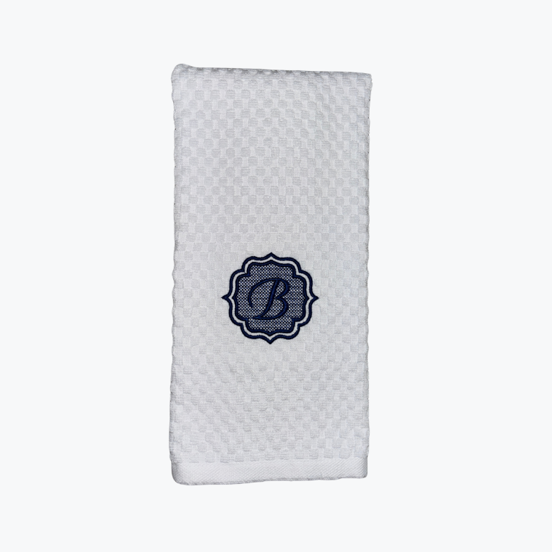 White textured dishtowel with a blue monogram "B" on a white background