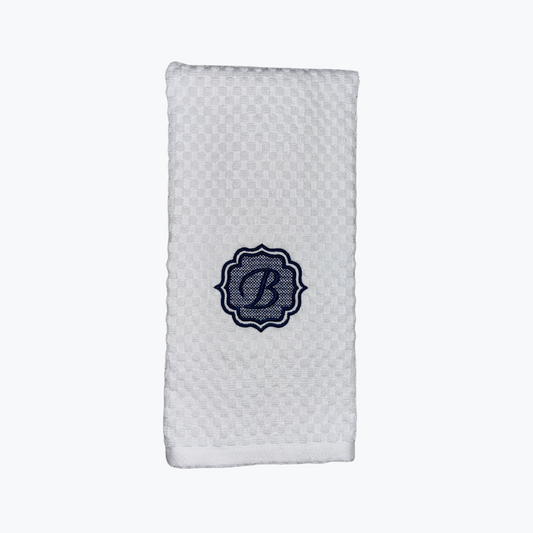 White textured dishtowel with a blue monogram "B" on a white background